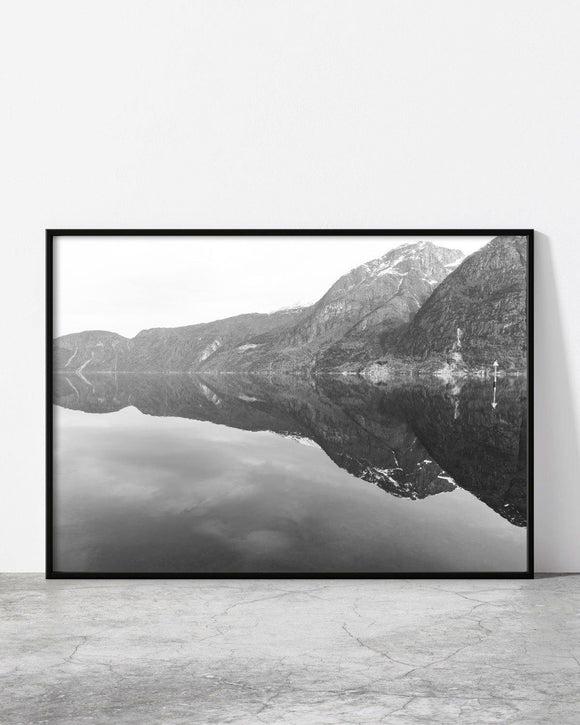 Serene monochrome mountain scenery with perfect water reflection.