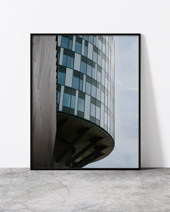Contemporary architecture print capturing a bold, curved facade with geometric window patterns.