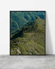 Green mountain print of a lush ridge dotted with yellow gorse above forested valleys, Madeira