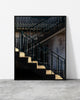 Staircase wall art of teal zig-zag railings and a shaft of light on a weathered concrete stairwell