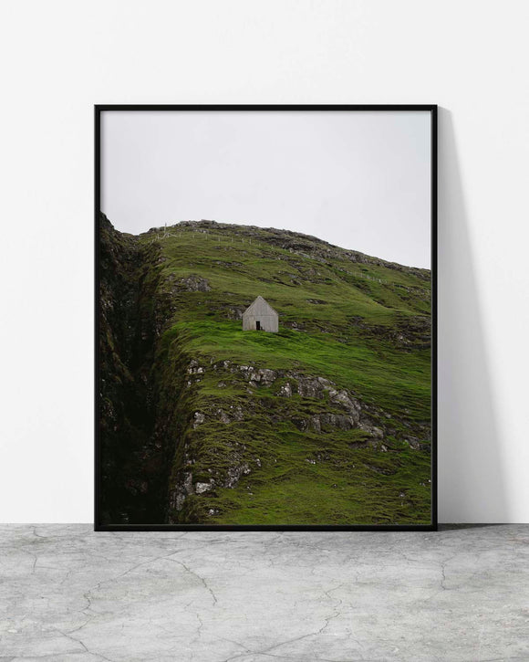 Framed photograph of a small building on a grassy hillside in Faroe Islands