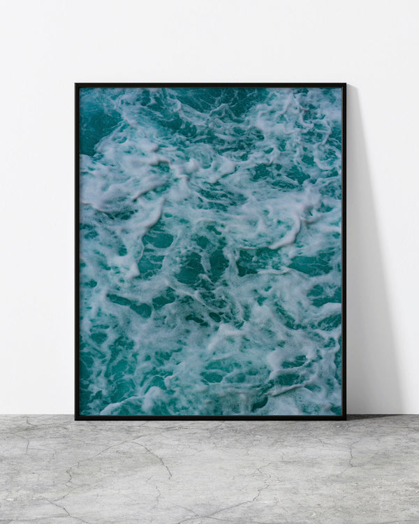 Abstract wave print of turquoise sea water and white foam seen from above, Madeira