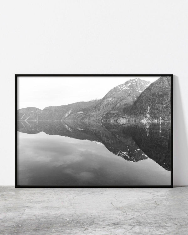 Serene monochrome mountain scenery with perfect water reflection.